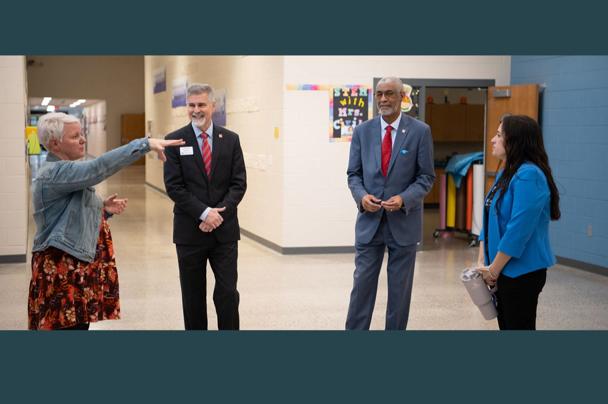 Woman pointing while two men and another woman look on
